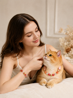 Woman with orange cat wearing a strawberry quartz collar, paired with matching owner bracelet.